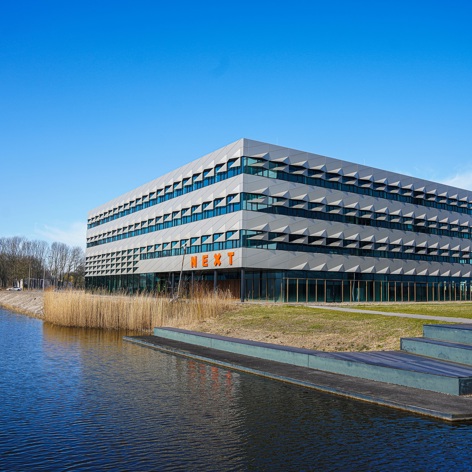 This slide displays NEXT Delft, TU Delft Campus LR.